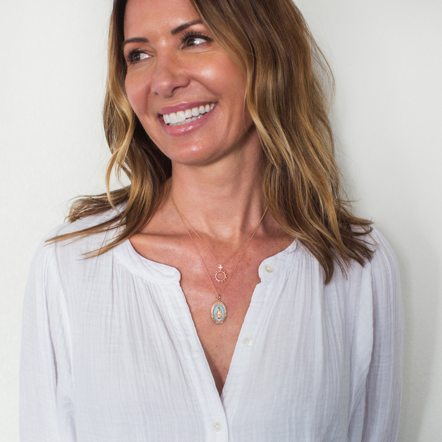 Woman wearing a Miraculous Medal and a Rosary Ring necklace in Rose Gold